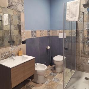 a bathroom with a toilet and a sink and a shower at Luppolo Amaro in Sommatino