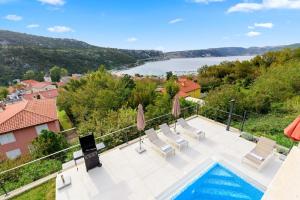 a villa with a swimming pool and a view of a river at Villa Adria Blue in Bakarac