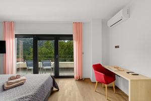 a bedroom with a bed and a desk with a red chair at Villa Adria Blue in Bakarac +39 photos