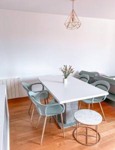ein Esszimmer mit einem weißen Tisch und Stühlen in der Unterkunft Petit cocon à Melun seul, en couple, entre amis ou en famille in Melun