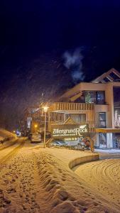 a snow covered street in front of a building at ZillergrundRock Luxury Mountain Resort in Mayrhofen
