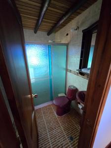a bathroom with two toilets and a glass door at La Kama in Duitama