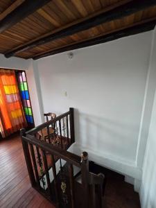 a wooden staircase with a stained glass window at La Kama in Duitama +7 photos