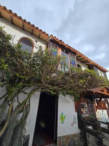 a house with a tree in front of it at La Kama in Duitama