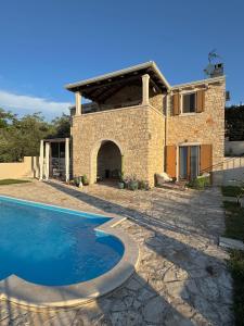 a house with a swimming pool in front of it at casa PRIANI in Krasica