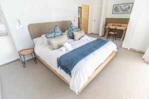 a bedroom with a large bed with blue and white pillows at Waterfront Estate F13 Swakopmund in Swakopmund