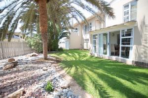 a palm tree in the yard of a house at Waterfront Estate F13 Swakopmund in Swakopmund