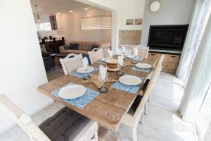 a dining room with a wooden table and chairs at Waterfront Estate F13 Swakopmund in Swakopmund
