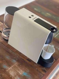 a coffee machine sitting on a wooden table at Casa aconchegante ao lado do Parque de Exposições in São Borja +36 photos