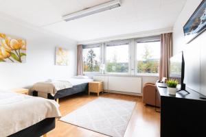 a bedroom with two beds and a window at Functional and cozy 3 bedroom apartment for 6 in Myyrmäki