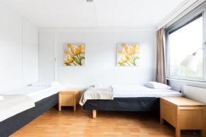 a bedroom with two beds and a window at Functional and cozy 3 bedroom apartment for 6 in Myyrmäki