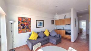 a living room with a couch and a kitchen at Margarida Seaview Terrace Apartment in Luz +11 photos