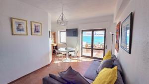 a living room with a couch and a view of the ocean at Margarida Seaview Terrace Apartment in Luz