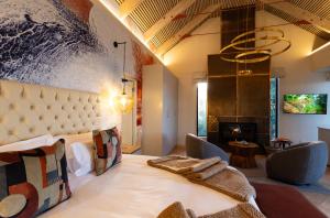 a bedroom with a large bed and a fireplace at Kunjani Villas & Wines in Stellenbosch +98 photos
