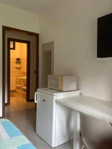 a kitchen with a microwave on top of a refrigerator at La Locanda Di Perico Paola in Veruno