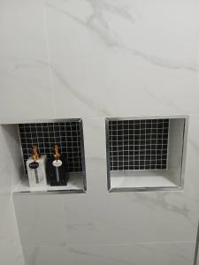 two bottles of soap sitting in the corner of a bathroom at ศรีทองคูณ เชียงคาน ซอย4 in Chiang Khan