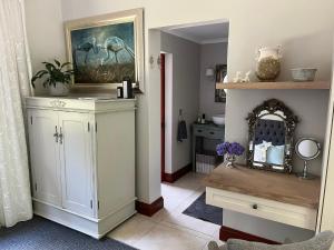 a bathroom with a white cabinet and a mirror at The Courtyard at La Loggia in Nottingham Road +36 photos