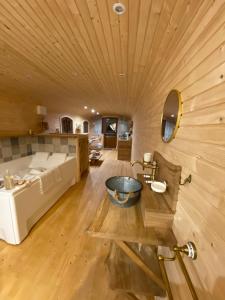 a bathroom with a bed and a sink in a room at La champ être in Neuville-sur-Sarthe