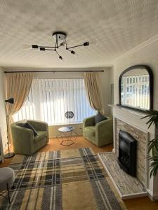 a living room with a couch and a fireplace at Beautiful 2 bed grd floor flat fantastic location in Eastbourne