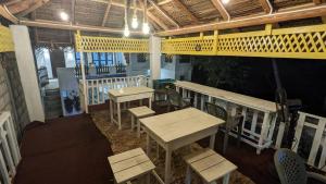 a restaurant with tables and chairs in a room at Parei Beach Inn in Tangalle
