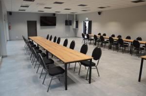 a conference room with a long wooden table and chairs at Ośrodek Sportu i Rekreacji w Janowcu Wielkopolskim in Janowiec Wielkopolski