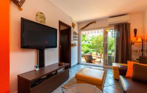 a living room with a flat screen tv on the wall at Ferienhaus Nina mit Whirpool by Villas Guide in Selce