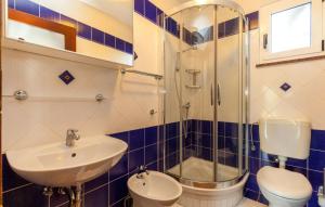 a bathroom with a sink and a shower and a toilet at Ferienhaus Nina mit Whirpool by Villas Guide in Selce +22 photos