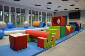 a play room with colorful chairs and tables at Ośrodek Sportu i Rekreacji w Janowcu Wielkopolskim in Janowiec Wielkopolski