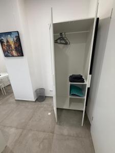 a white closet with a shelf in a room at Schönes Zimmer-1 in Stuttgart-Mitte in Stuttgart