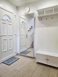 a hallway with a white door and a mirror at Charming family villa in Geneva