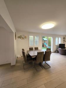 a dining room with a table and chairs at Charming family villa in Geneva