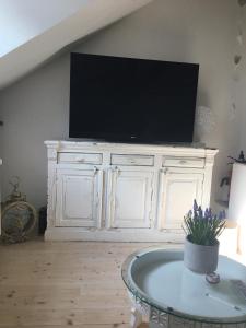 a white cabinet with a television on top of it at Historisches Designer Loft Nähe Waldorfer Höfe in Ochtendung +29 photos