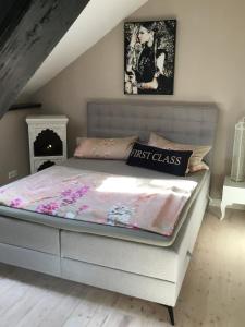 a bedroom with a bed with a first class bedspread at Historisches Designer Loft Nähe Waldorfer Höfe in Ochtendung