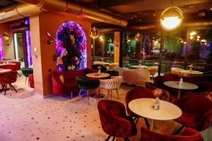 a restaurant with tables and chairs and a christmas tree at PARK INN, Bugojno in Bugojno