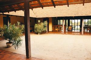 a patio with tables and chairs in a building at Panai Adi Boutique Villa in Kuravankudil +6 photos