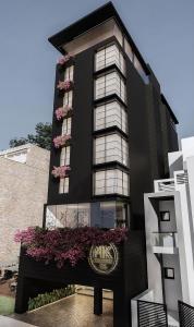 a black building with pink flowers on it at MK Colombo in Colombo