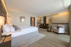 a hotel room with a bed and a desk at Pullman Munich in Munich