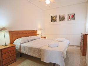 a bedroom with a bed with two towels on it at 053 - Altomar II 003 - comfortHOLIDAYS in Gran Alacant +15 photos
