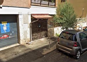 a small car parked in front of a garage at MVM Apartment in Rome