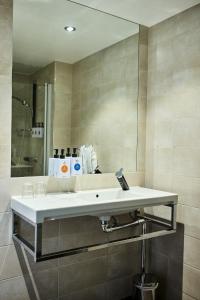 a bathroom with a white sink and a mirror at Quality Hotel Maritim in Haugesund
