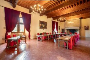 a large dining room with tables and red chairs at Chateau des Ducs de Joyeuse, BW Signature Collection in Couiza +123 photos