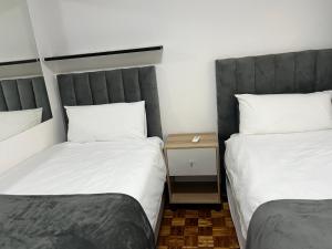 two beds sitting next to each other in a room at 8 on Lorenzo in Amanzimtoti +1 photo