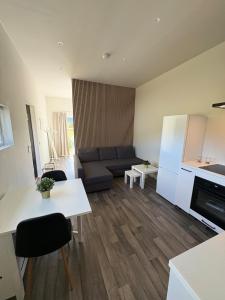 a living room with a couch and a table at Apartment in Målselv in Björklid +4 photos