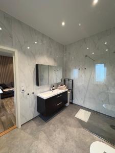 a bathroom with a sink and a shower at Apartment in Målselv in Björklid