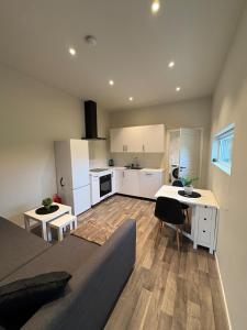 a kitchen and living room with white cabinets and a table at Apartment in Målselv in Björklid