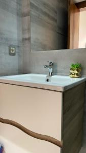 a bathroom with a white sink and a mirror at Facelift in Tangier
