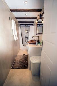 a small bathroom with a sink and a toilet at Victor's Traditional House in Chlomós