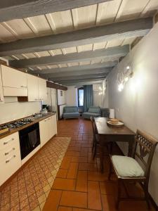 a kitchen and dining room with a table and chairs at Rota's House in Bergamo +29 photos