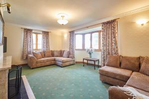 a living room with two couches and a couch at Host & Stay - Cherry Willows in Stainsacre