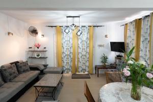 a living room with a couch and a table at Spacious Coastal Home Steps from the Beach in Flic-en-Flac